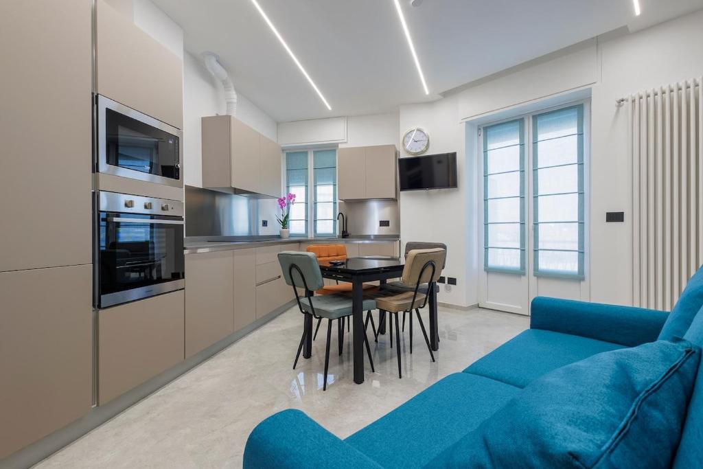 a living room with a blue couch and a table at La Suite Nel Borgo - Ai Piedi delle Alpi&Centro Storico in Borgo San Dalmazzo