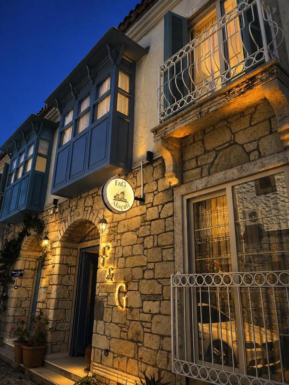 a building with a clock on the side of it at F&G Alaçatı in Alaçatı