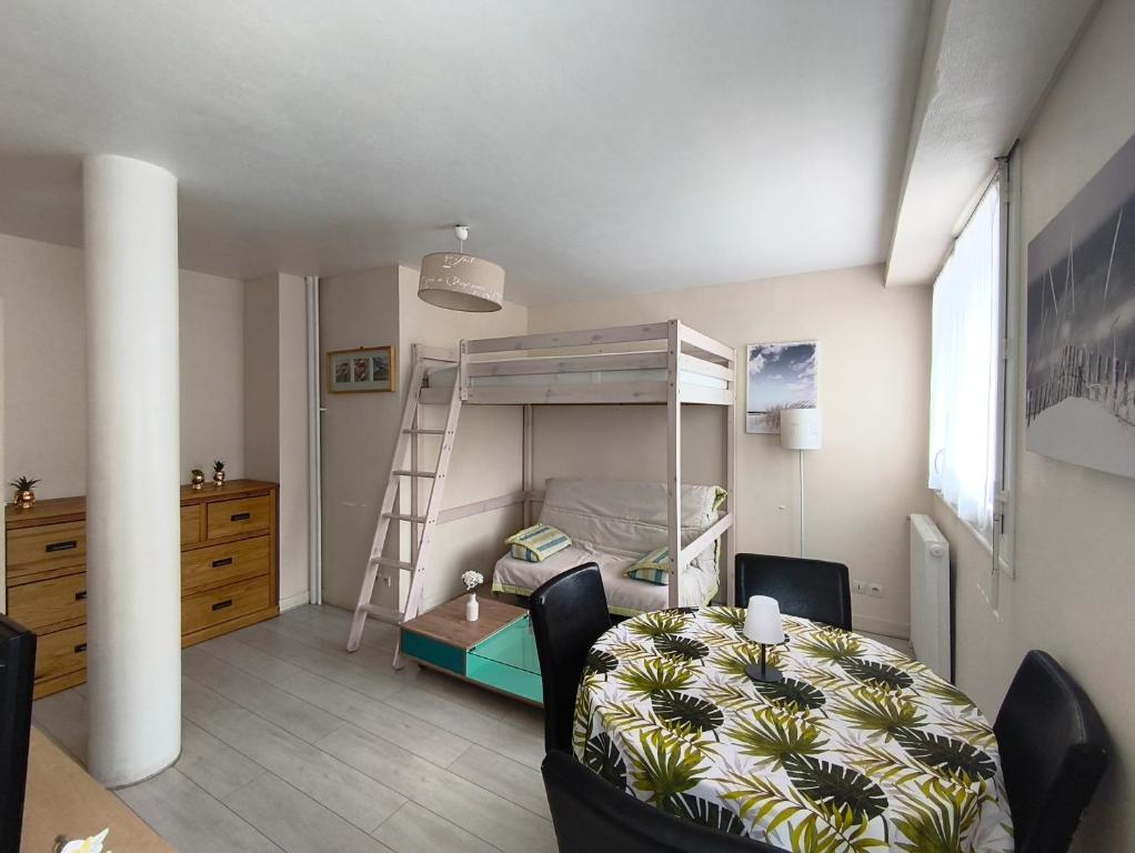 a bedroom with a bunk bed with a table and a chair at Studio cosy proche plage & centre in Le Havre