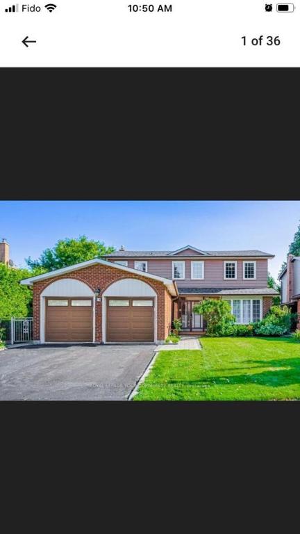 a picture of a house with two garage doors at Mill pond cozy and private 2 in Richmond Hill