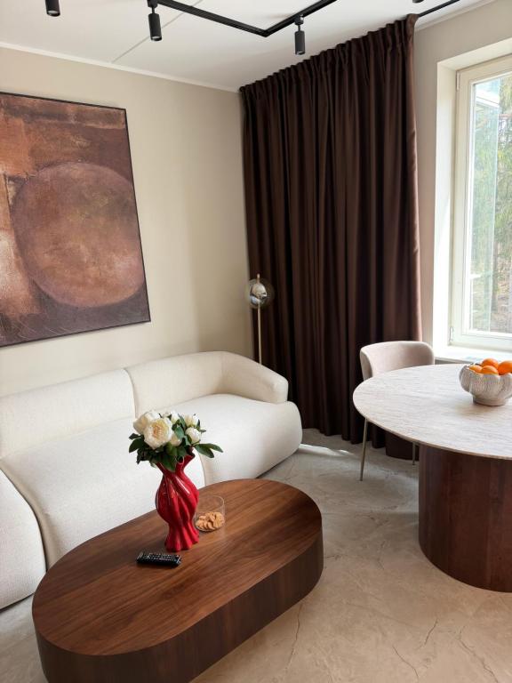 a living room with a white couch and a table at The Baltic Sea Hideaway in Narva-Jõesuu