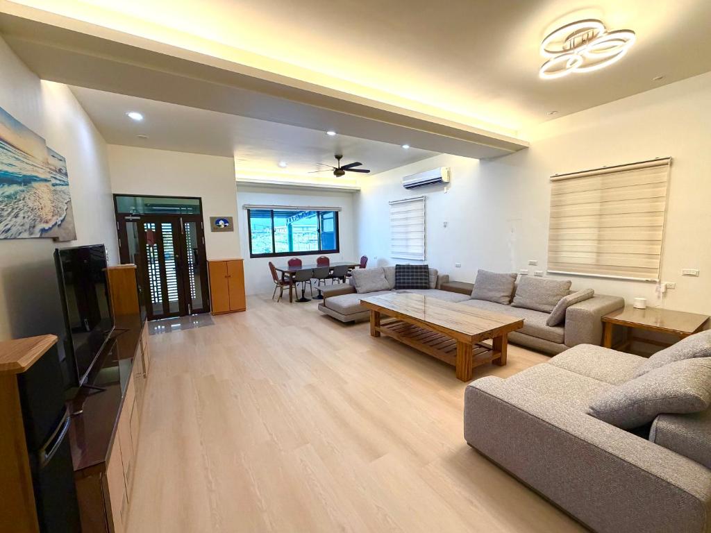 a living room with a couch and a table at 晨溪民宿 in Wujie