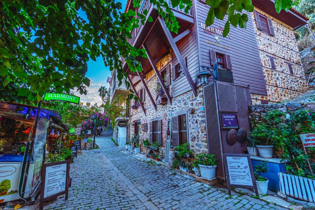 a cobblestone street next to a building with plants at Harmony Butik Otel in Alanya