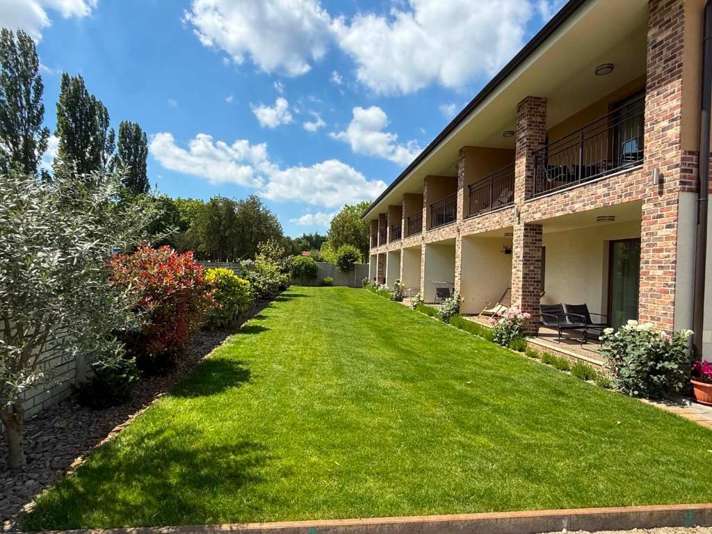 a large yard in front of a building at VILLA MEGER in Veľký Meder