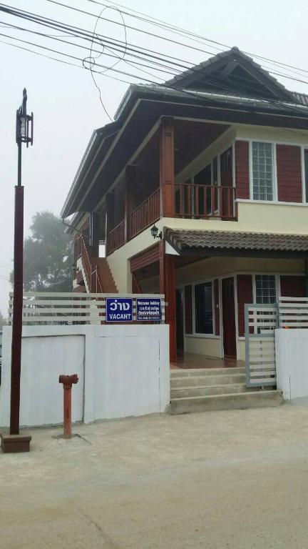 a house with a fire hydrant in front of it at Welcome holiday in Chiang Khan