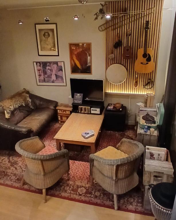 a living room with a couch and a table at B2B Apartment Creamundi in Lokeren