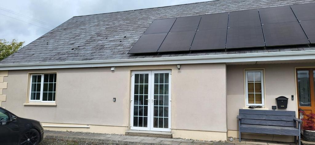 a house with solar panels on the roof at Ox Mountain View 3 Bed apartment in Foxford