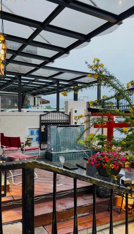 a patio with a table with flowers on it at Love's World B&B in Ji'an