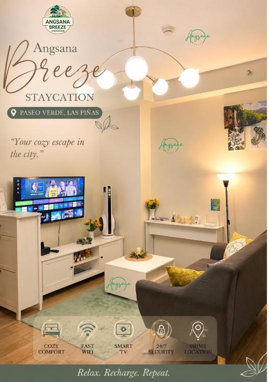 a living room with a couch and a tv at Angsana Breeze at Paseo Verde Las Piñas in Manila