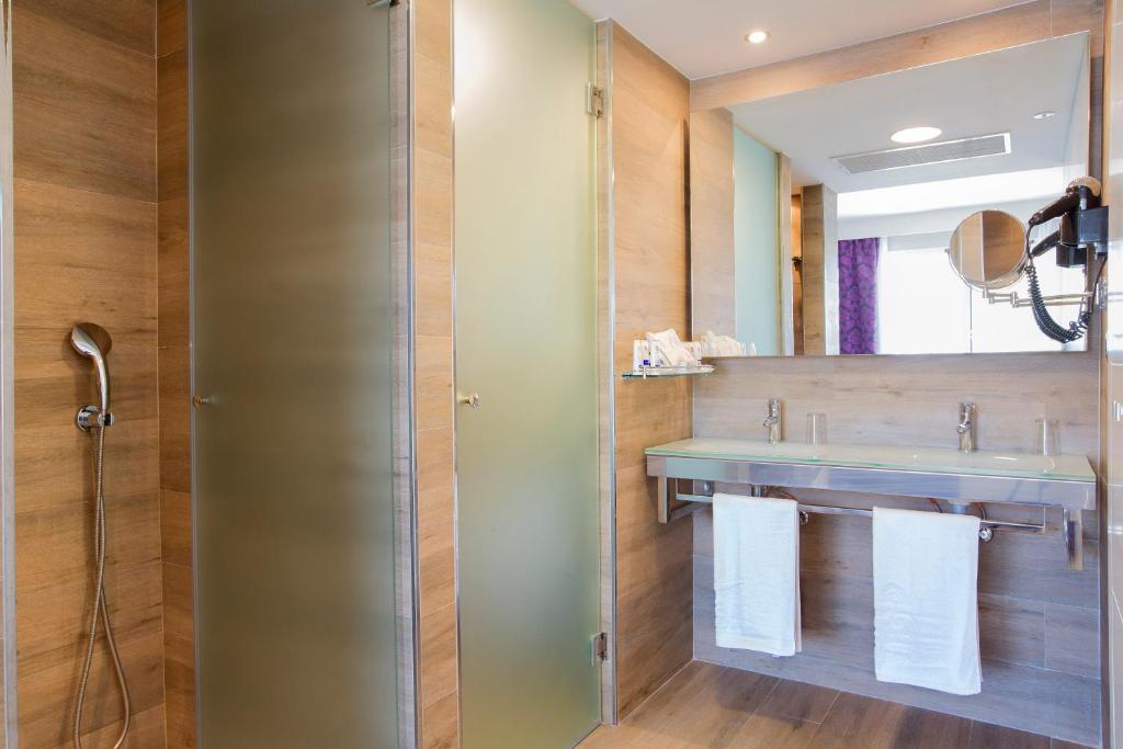 a bathroom with a sink and a mirror at Mar Hotels Playa de Muro Suites in Playa de Muro