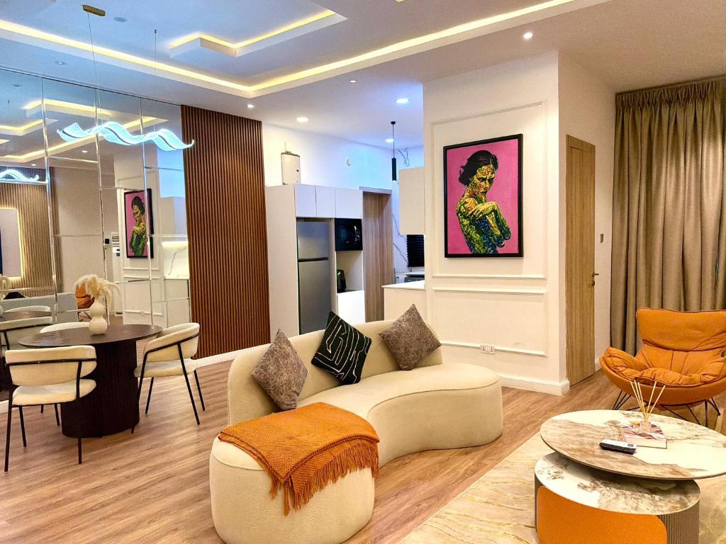 a living room with a couch and a table at Luxury 1 BR With Swimming Pool & 24 Hours Security In Lekki 1 in Lagos