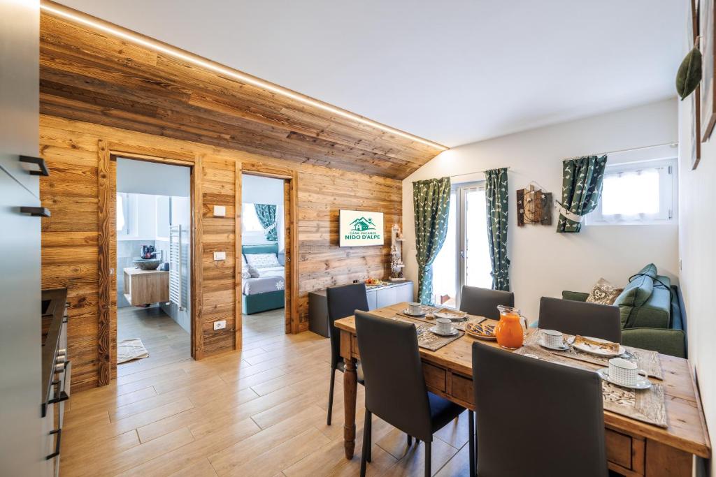 a dining room and living room with a table and chairs at CHALET LAURA apricacasevacanze in Aprica