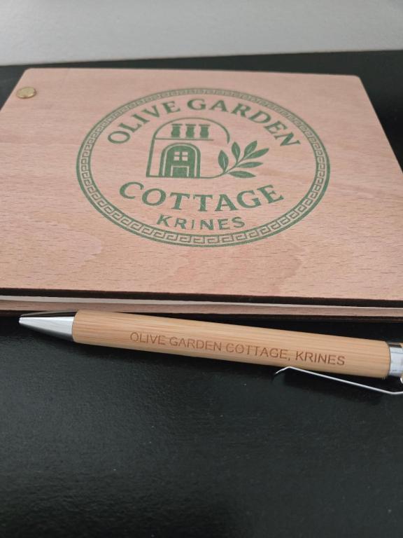 a wooden box with a pen on top of it at Olive garden cottage, Krines in Vélon
