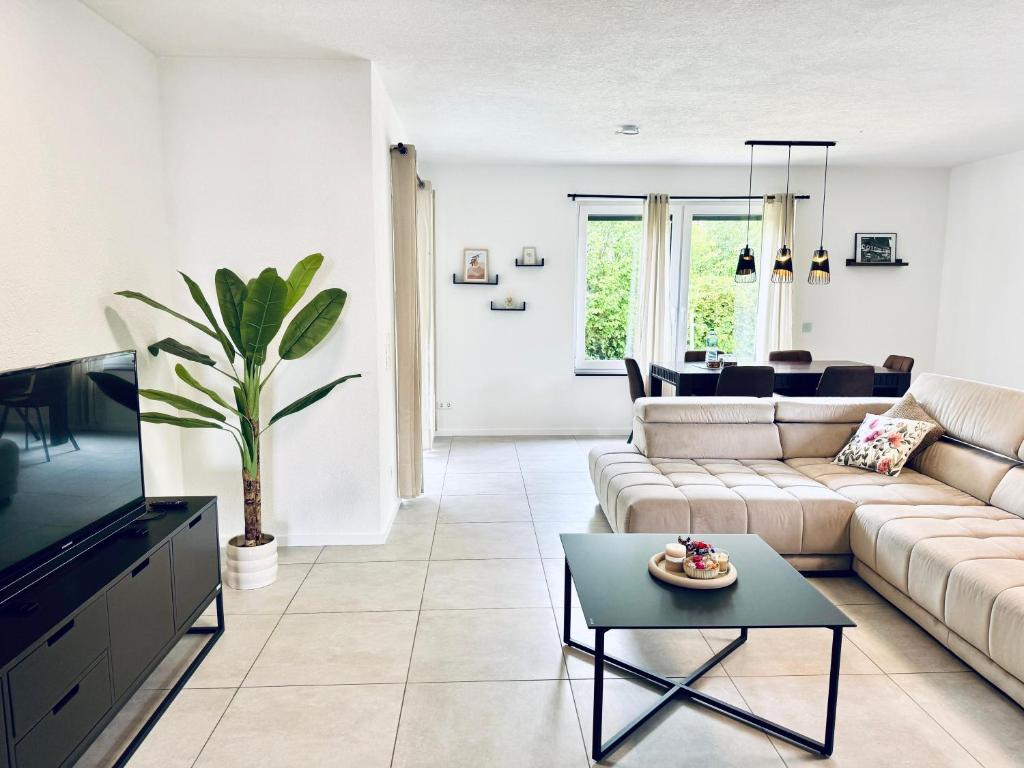 a living room with a couch and a table at KiNi Unterkunft in Hörstel