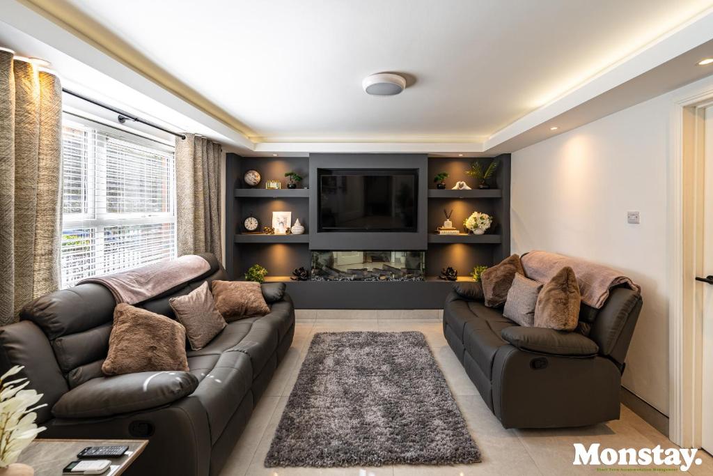 a living room with a couch and a tv at Walled City House in Derry Londonderry