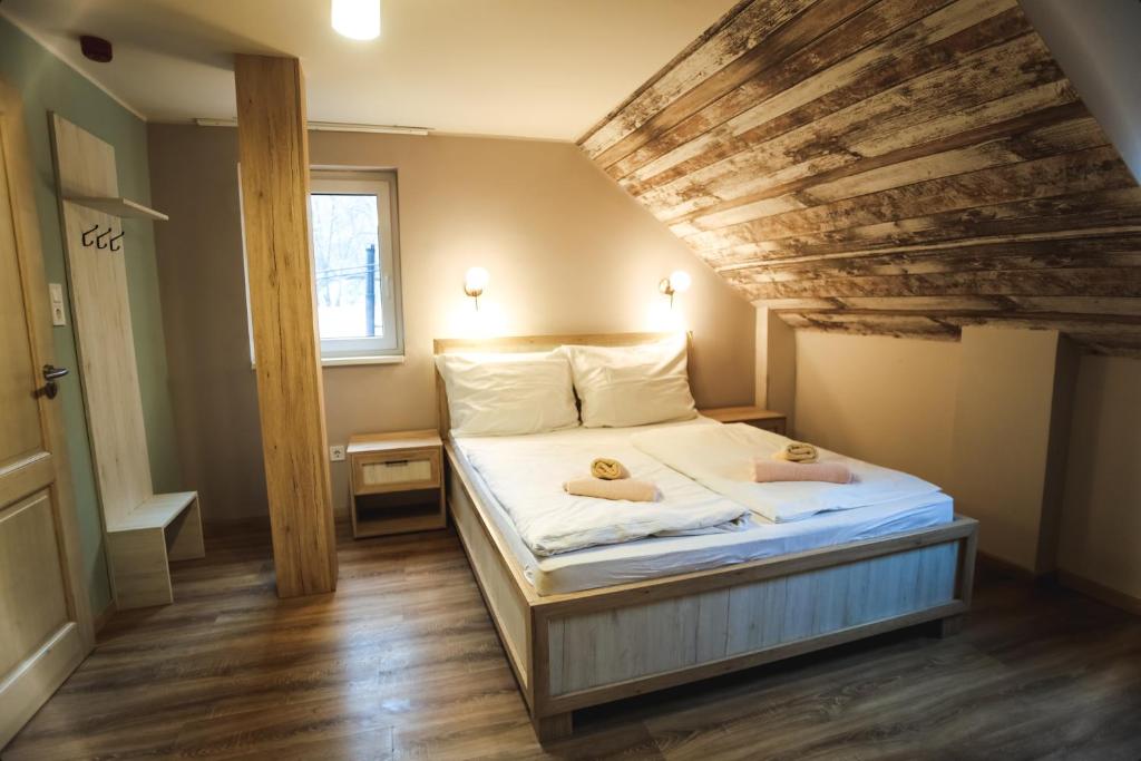 a bedroom with a bed with two towels on it at Eged Panzió Eger in Eger