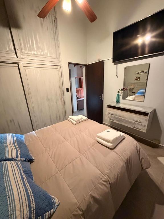 a bedroom with a bed with two towels on it at Mi hogar in Guaymallen