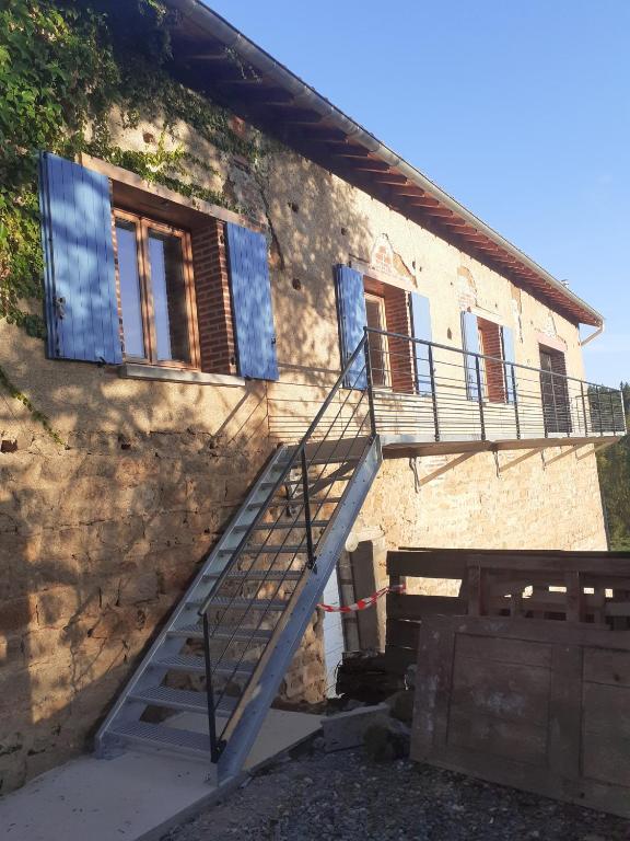 a staircase leading up to a building with windows at Chambres D'hôtes Les Noisetiers in Saint-Martin-Lestra