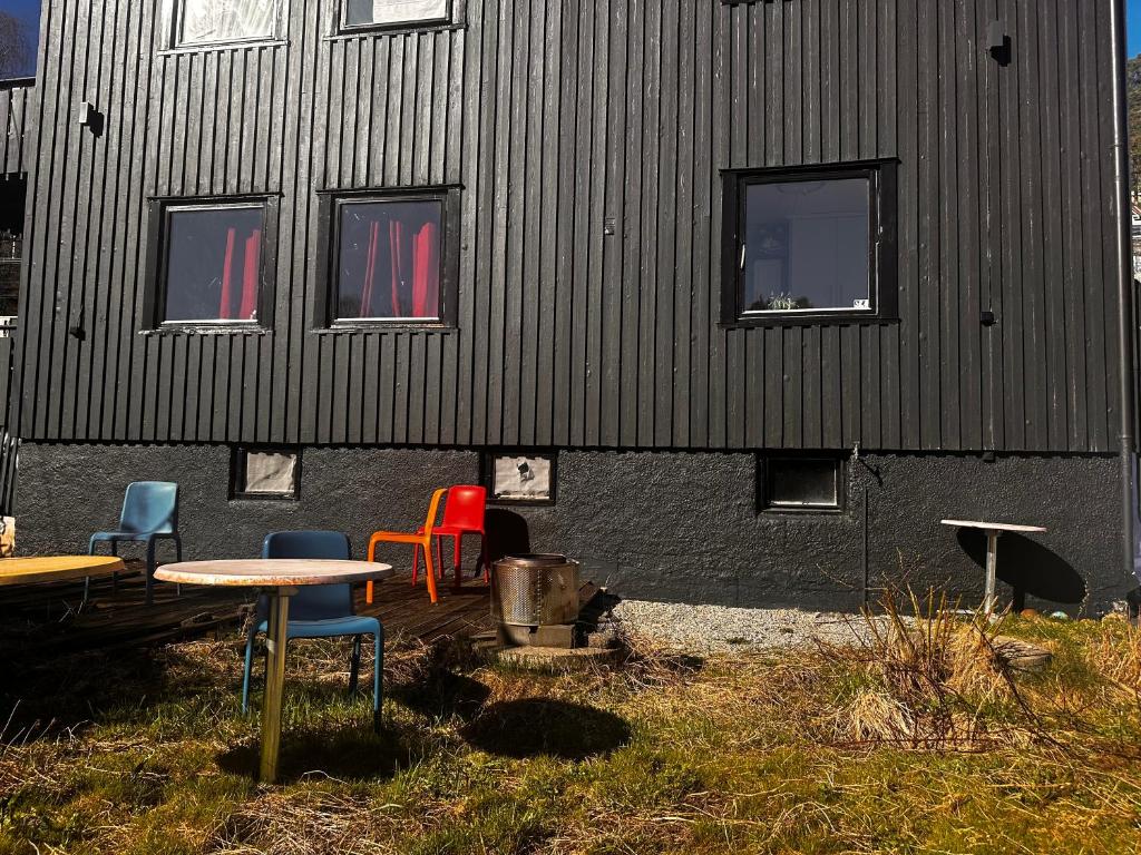a group of chairs and tables in front of a building at Nordstrands Ro in Oslo