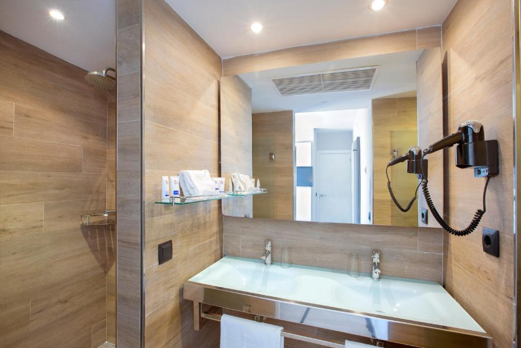 a bathroom with a sink and a mirror at Mar Hotels Playa de Muro Suites in Playa de Muro
