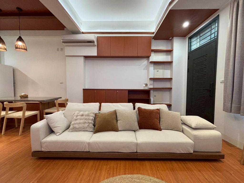 a living room with a white couch and a table at White in Gukeng