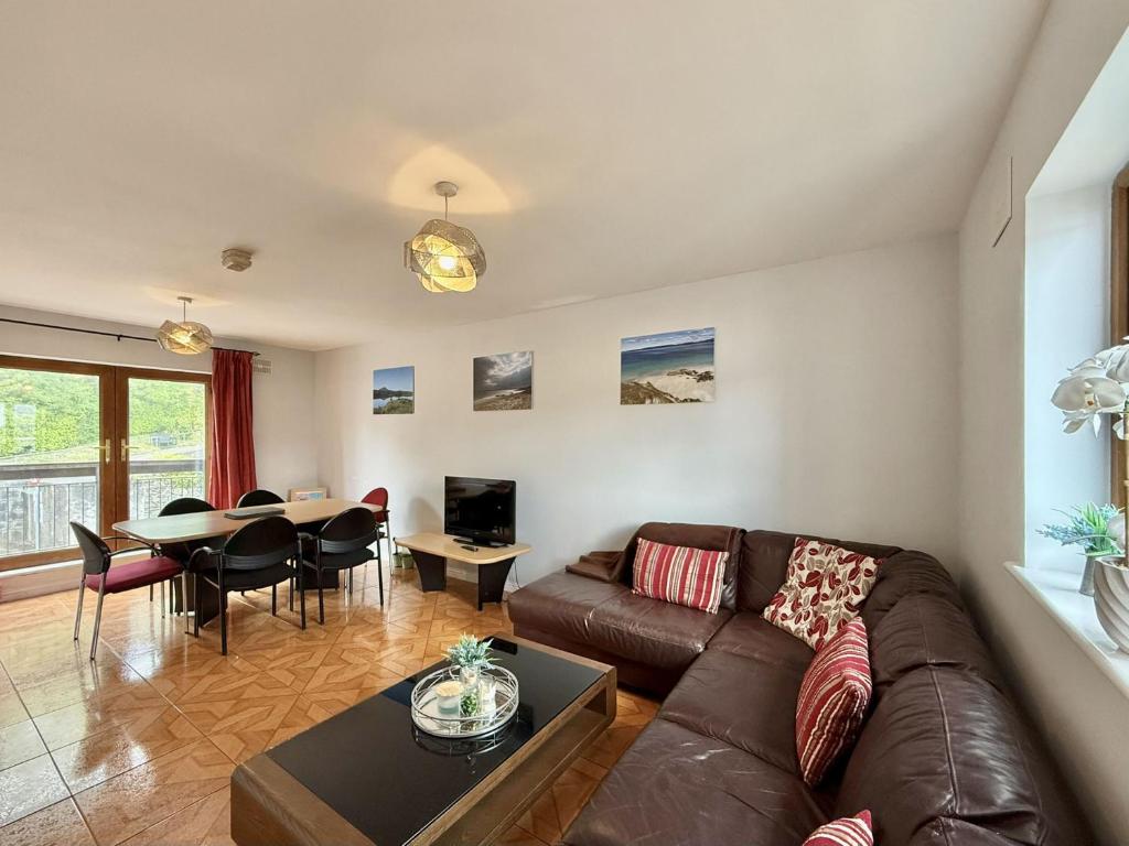 a living room with a couch and a table at Apartment 514 - Clifden in Clifden