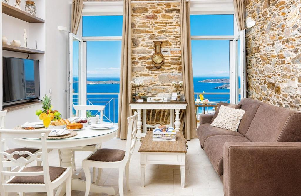 a living room with a couch and a table at TOP SUITES in Ermoupoli