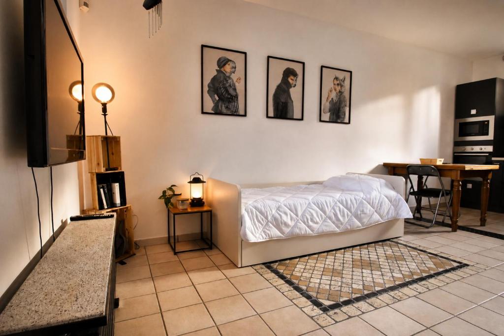 a bedroom with a white bed and a table and a tableablish at The Other Side in Lainate