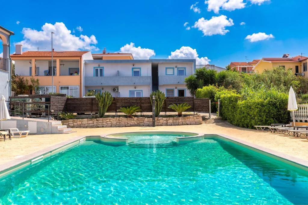 a swimming pool in the backyard of a villa at Appartamenti Abbaidda 4 in Valledoria
