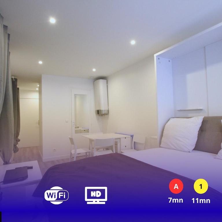 a bedroom with a bed and a table in it at Top Studio SV1020 Centre Vincennes 20M2 in Vincennes