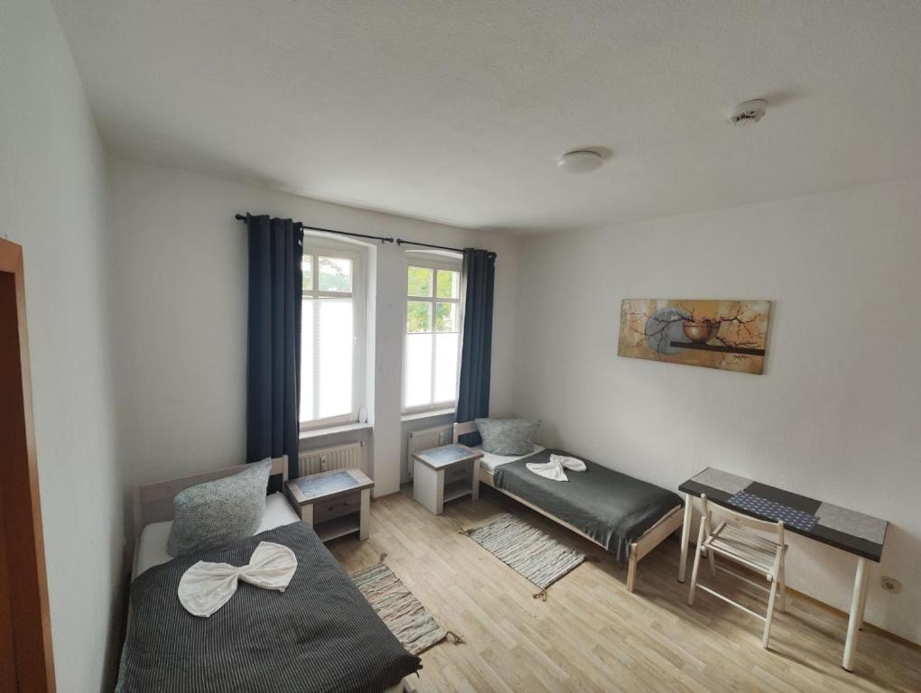 a living room with a bed and a desk at Revant West 2 in Arnstadt