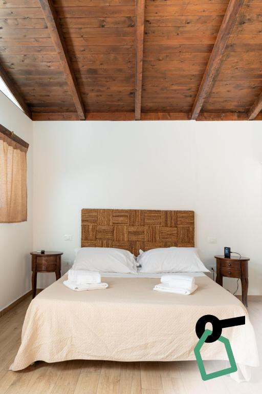 a bedroom with a large bed with two towels on it at Hotiday Otranto Porto in Otranto