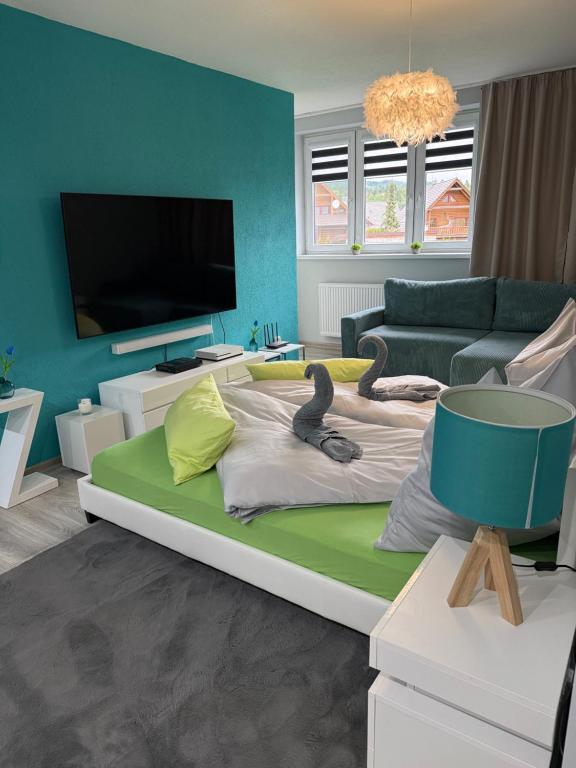 a living room with a large bed with swans on it at Modern Oasis in Nová Lesná