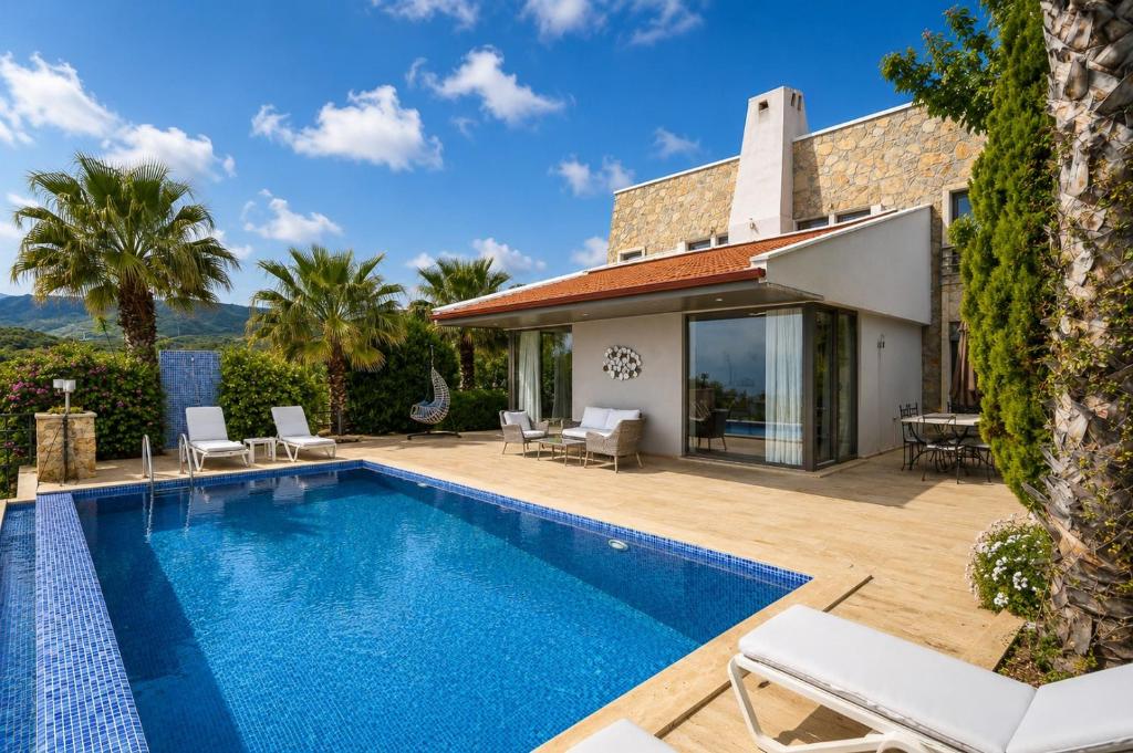 a villa with a swimming pool and a house at Villa Emilie in Kaş