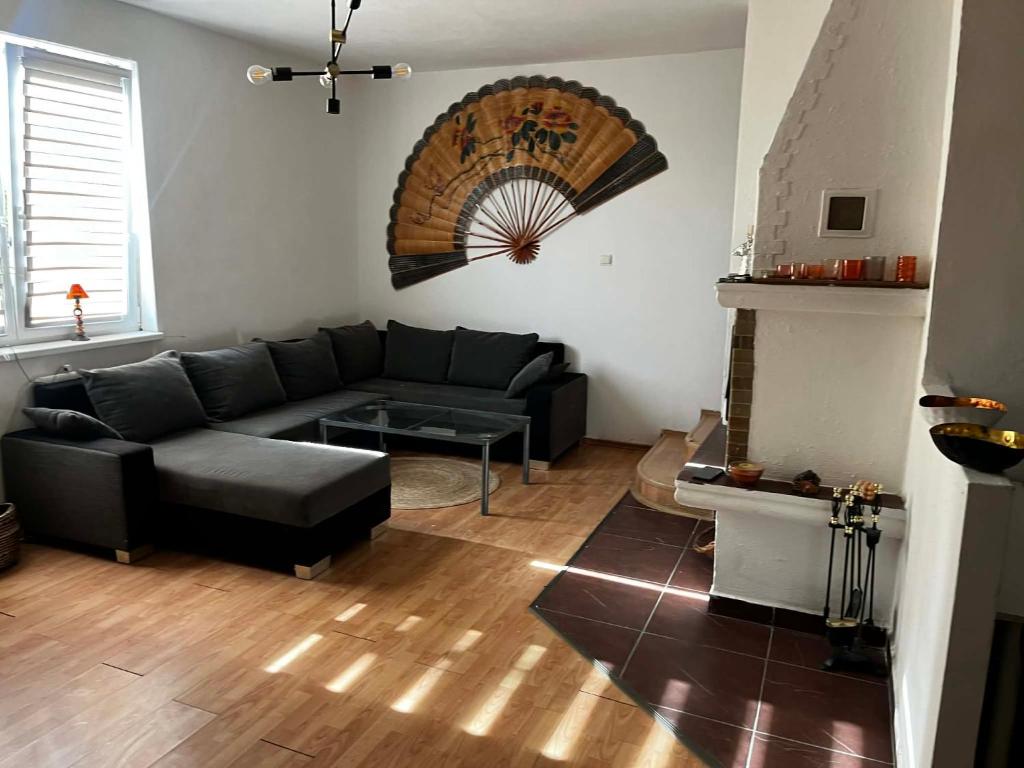 a living room with a couch and a fireplace at Útulný dom blízko Košíc in Sokoľany