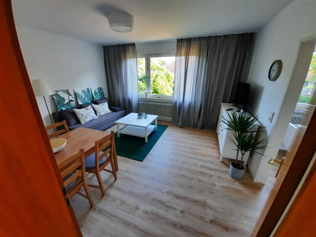 a living room with a table and a couch at Rikes Ferienwohnung 2 in Heinsberg