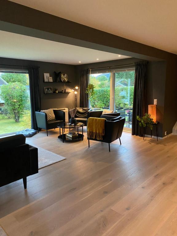 a living room with furniture and a large window at Yttermoveien in Narvik