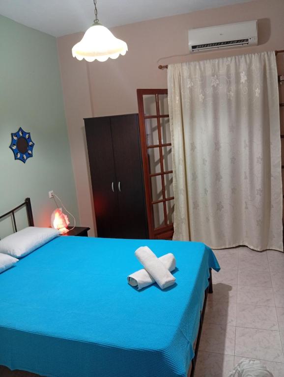 a bedroom with a blue bed with towels on it at Irida mariaSmall studio in Agios Ioannis Pelio