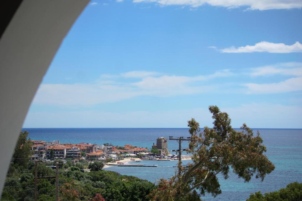 a view of a city and the ocean from a hill at Villa Elizabeth Apartments in Ouranoupoli