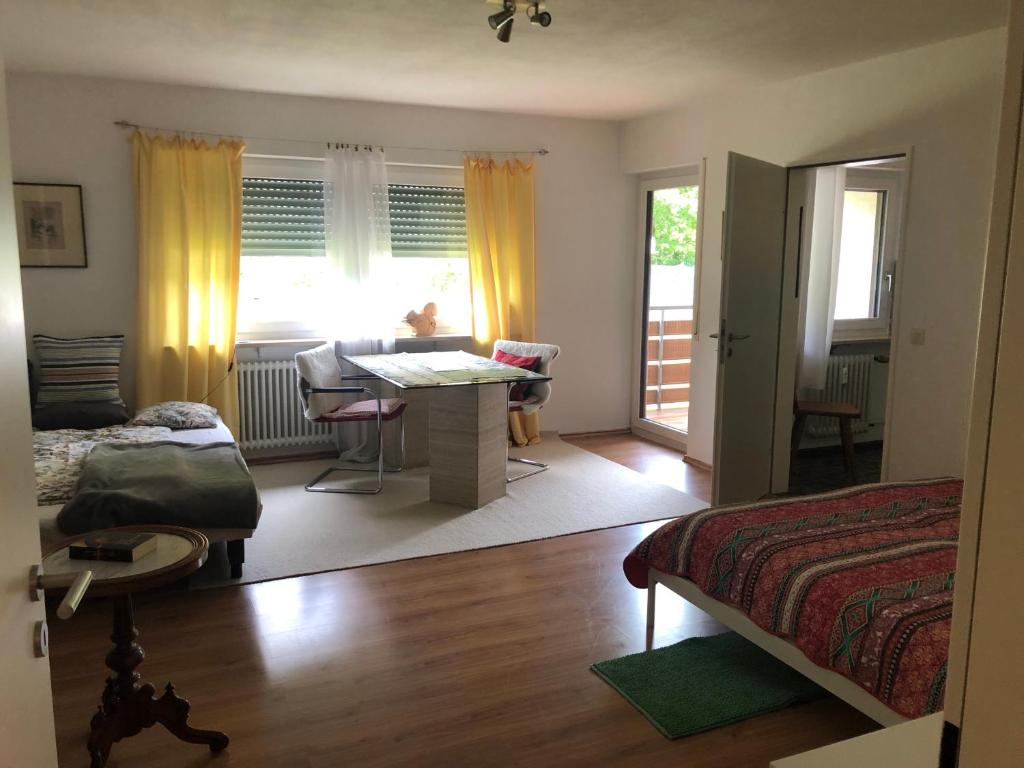a bedroom with a bed and a desk in a room at Eichhörnchens Paradies in Todtmoos