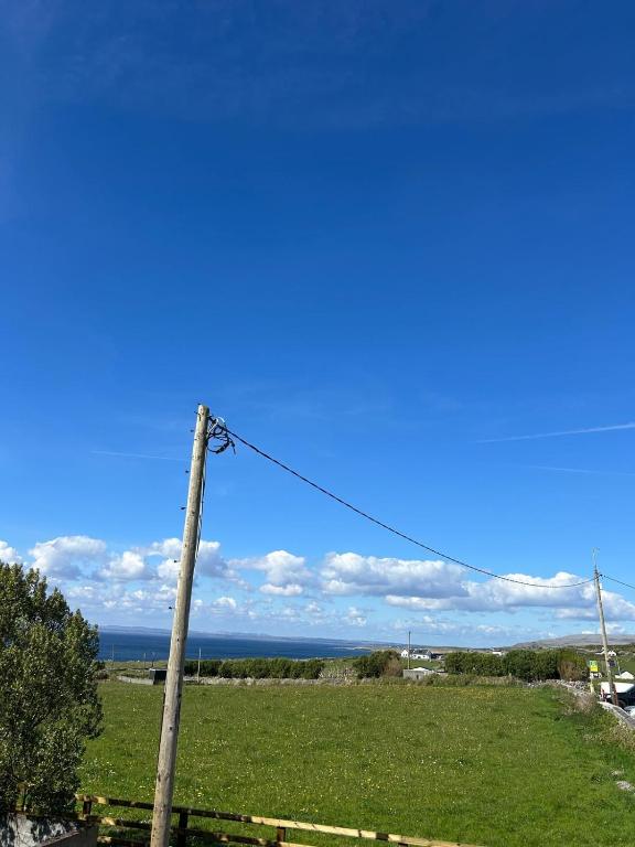a telephone pole with the ocean in the background at Fanore Apartment 3 in Fanore