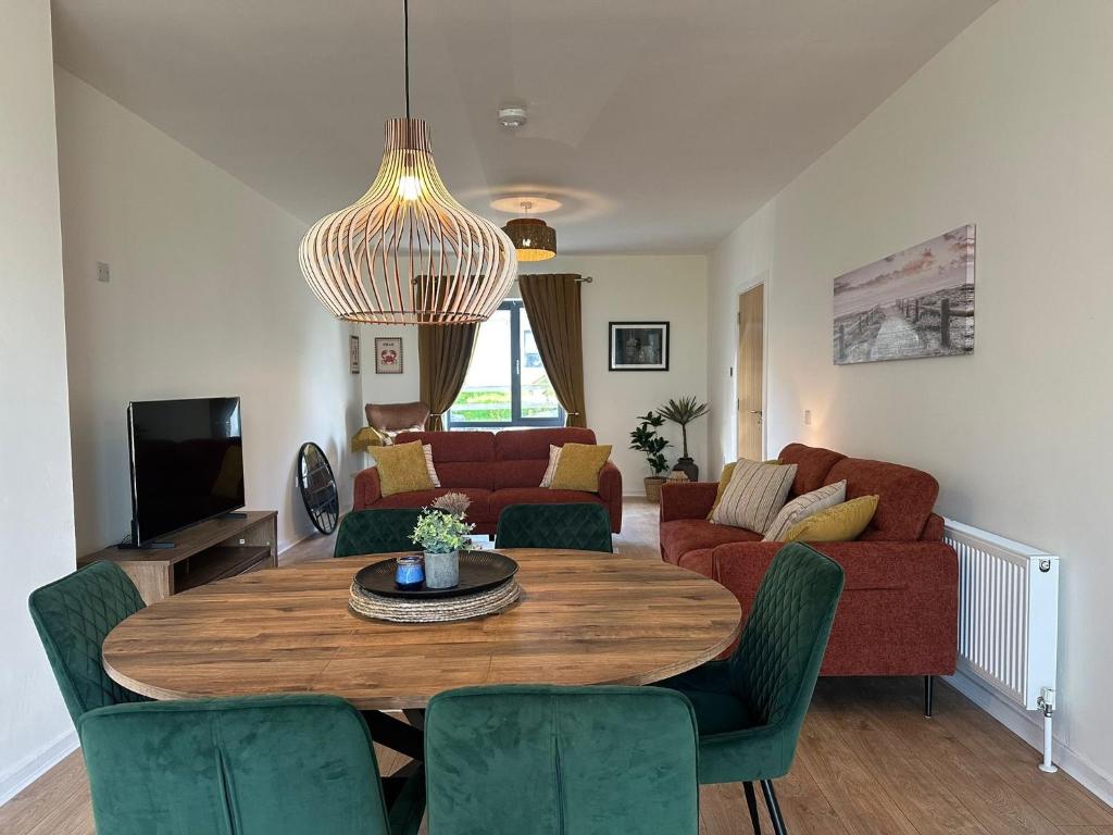 a living room with a table and a couch at House Sleeps 6 with Parking in Coad