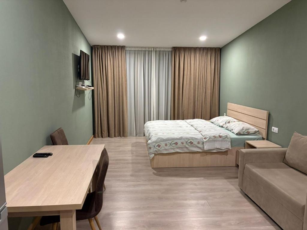 a small room with a bed and a couch at Bakuriani Valley 09 in Bakuriani