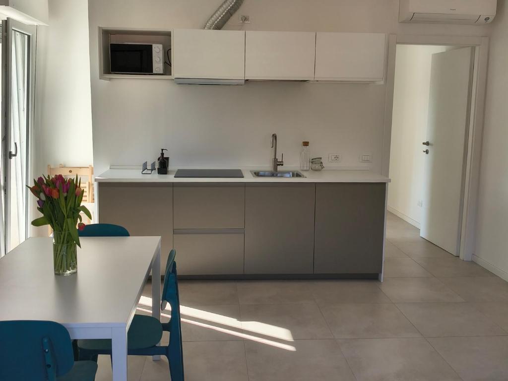 a kitchen with a table and a sink and a counter at Casa Bolina in Senigallia