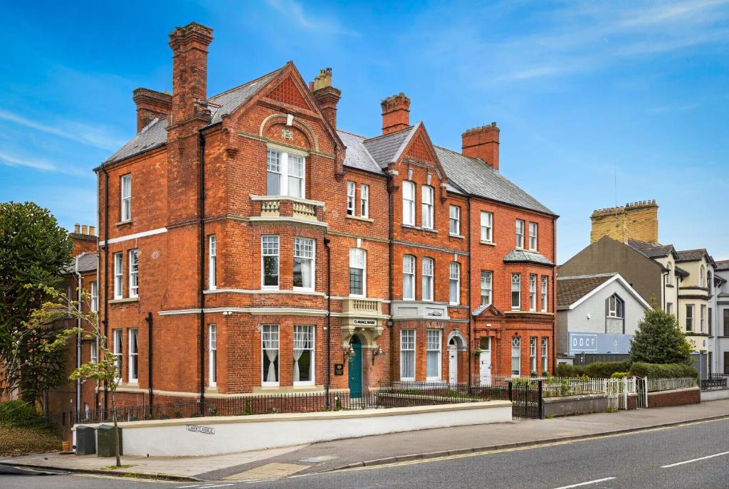 a large red brick building on a city street at Clarence House in Derry Londonderry