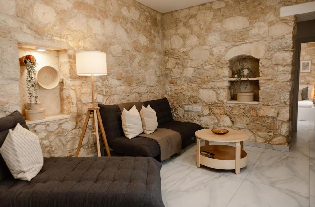 a living room with a couch and a table at Old Luxury Stone House Armou in Armu
