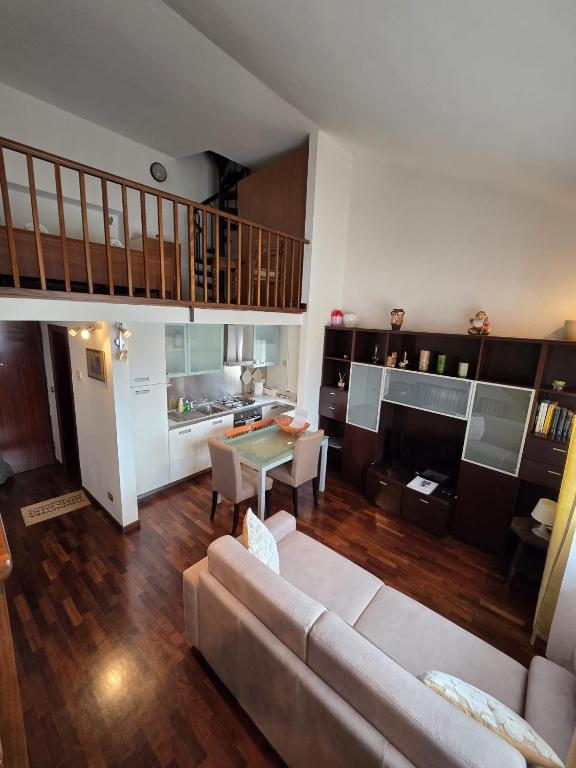 a living room with a couch and a table at VeronaVera Porta Palio Panoramic Loft in Verona