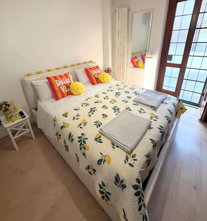 a bedroom with a large bed with a comforter at Lemon House in Stezzano