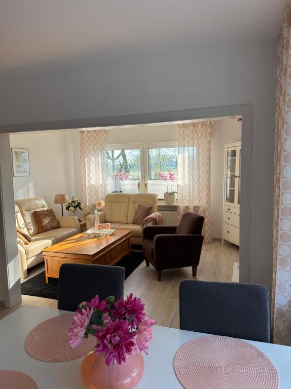 a living room with a couch and a table at Vakantiewoning MaRa in Neuenhaus