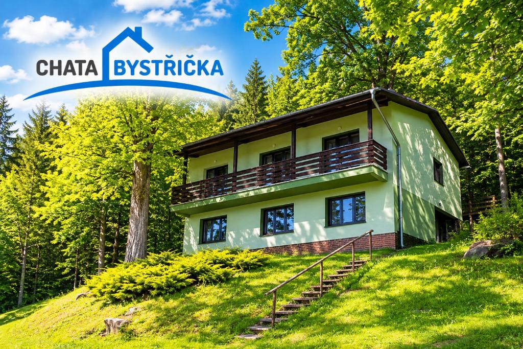 a house on top of a hill in the forest at Chata Bystřička in Velká Lhota